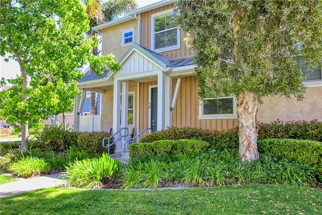 3591 Sacramento Dr Unit 50, San Luis Obispo, CA 93401 - view of front of property with covered porch, board and batten siding, and a front yard