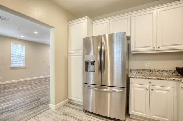 3591 Sacramento Dr Unit 50, San Luis Obispo, CA 93401 - kitchen featuring stainless steel refrigerator with ice dispenser, white cabinets, recessed lighting, light wood-type flooring, and light stone countertops