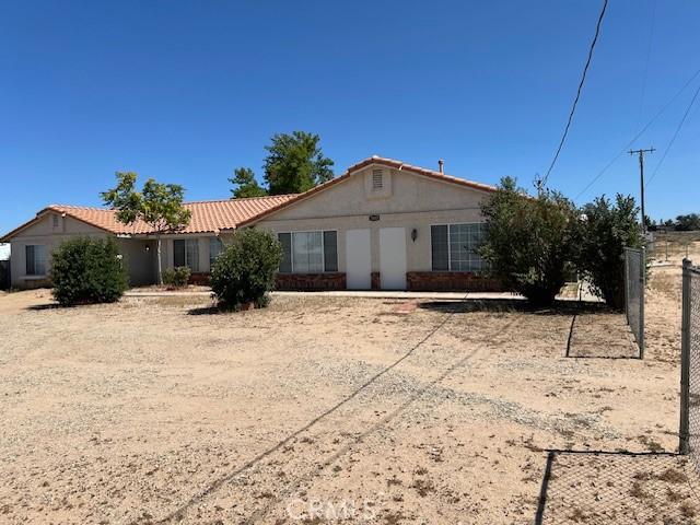 7653 Phelan Rd, Phelan, CA 92371 - single story home with stucco siding and a tile roof