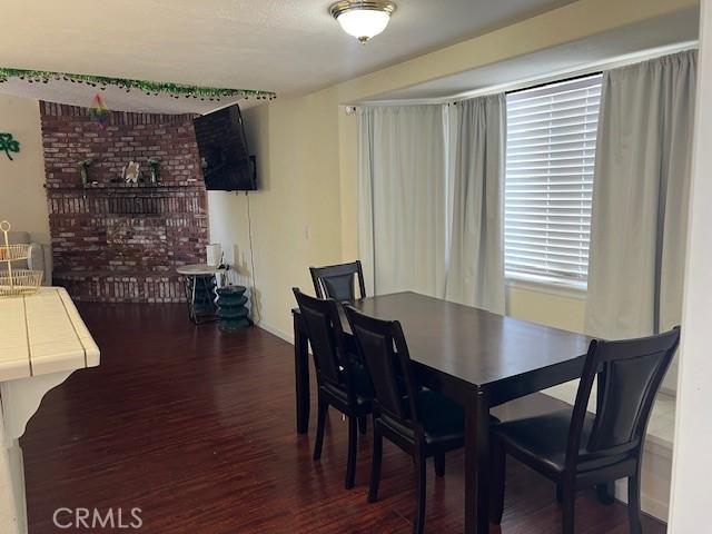 7653 Phelan Rd, Phelan, CA 92371 - dining area with wood finished floors and a fireplace