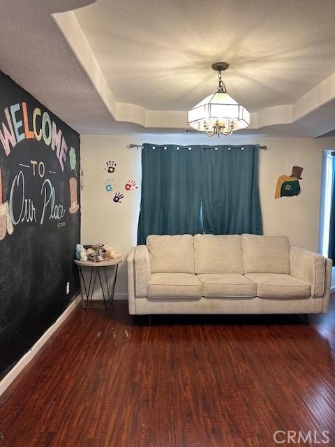 7653 Phelan Rd, Phelan, CA 92371 - living room featuring wood finished floors and a chandelier