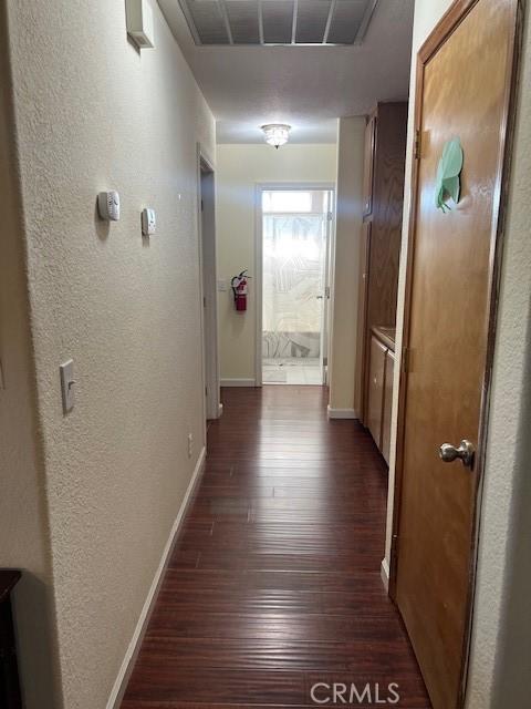 7653 Phelan Rd, Phelan, CA 92371 - hall featuring dark wood-type flooring and a textured wall