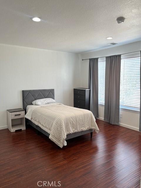 7653 Phelan Rd, Phelan, CA 92371 - bedroom featuring wood finished floors, recessed lighting, and a textured ceiling