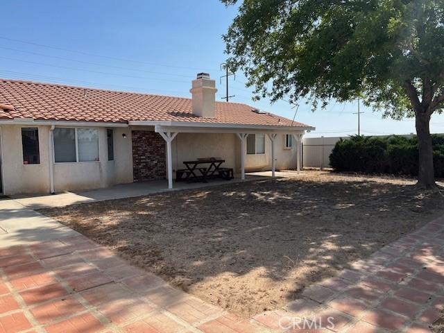 7653 Phelan Rd, Phelan, CA 92371 - back of house with a patio area, a chimney, stucco siding, and a tile roof