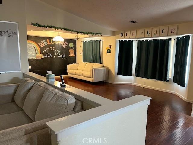 7653 Phelan Rd, Phelan, CA 92371 - living area featuring wood finished floors and vaulted ceiling