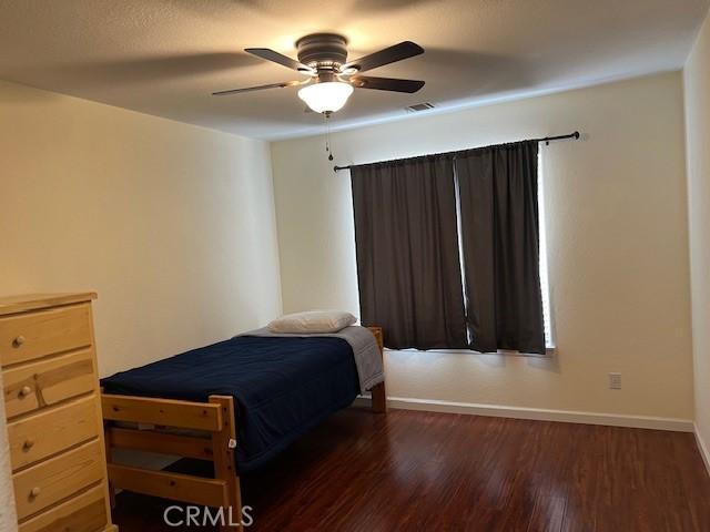 7653 Phelan Rd, Phelan, CA 92371 - bedroom with wood finished floors and ceiling fan