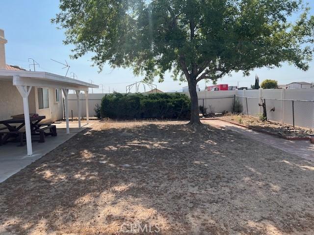 7653 Phelan Rd, Phelan, CA 92371 - fenced backyard with a patio area