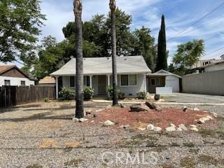 322 E 11th St, Beaumont, CA 92223 - view of front facade featuring driveway, a garage, and an outdoor structure