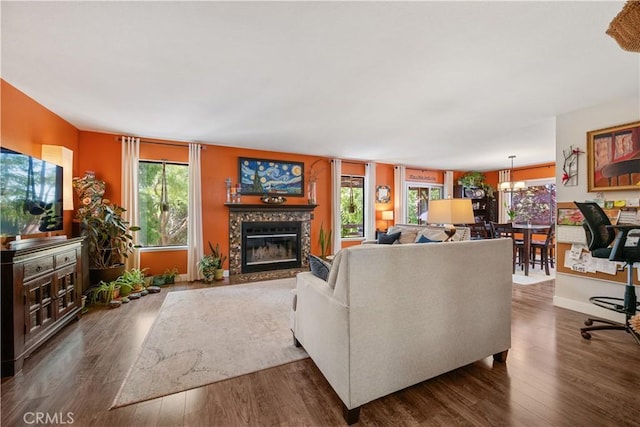 1024 Rachel Ln, Paso Robles, CA 93446 - living area featuring dark wood-style flooring, a tile fireplace, and a chandelier