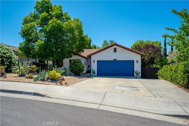 1024 Rachel Ln, Paso Robles, CA 93446 - mediterranean / spanish-style home with stucco siding, an attached garage, concrete driveway, and a tiled roof