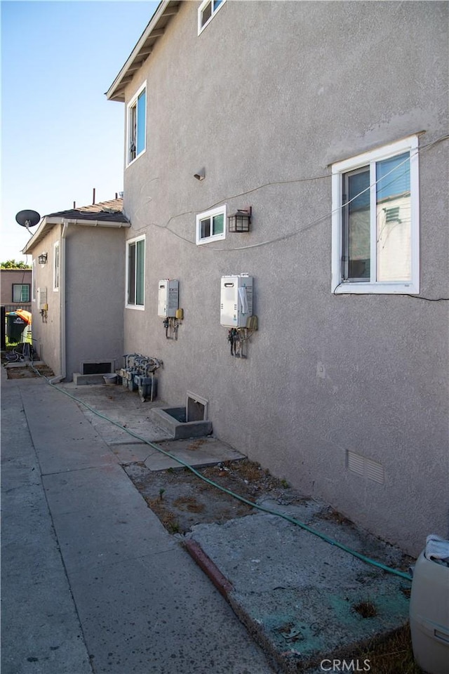 2913 Illinois Ave, South Gate, CA 90280 - view of home's exterior with stucco siding and a patio area