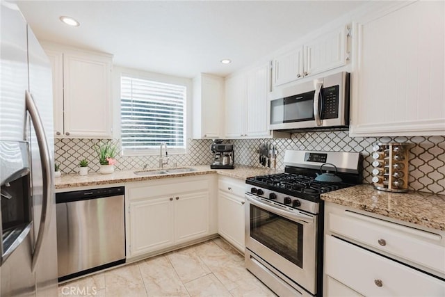 20334 Rue Crevier Unit 621, Canyon Country, CA 91351 - kitchen featuring stainless steel appliances, decorative backsplash, white cabinets, light stone countertops, and recessed lighting