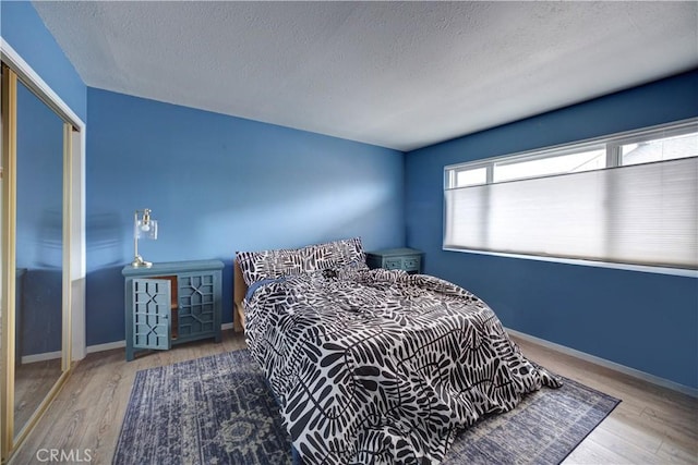 641 Piney Way Unit D, Morro Bay, CA 93442 - bedroom with a textured ceiling, wood finished floors, and a closet