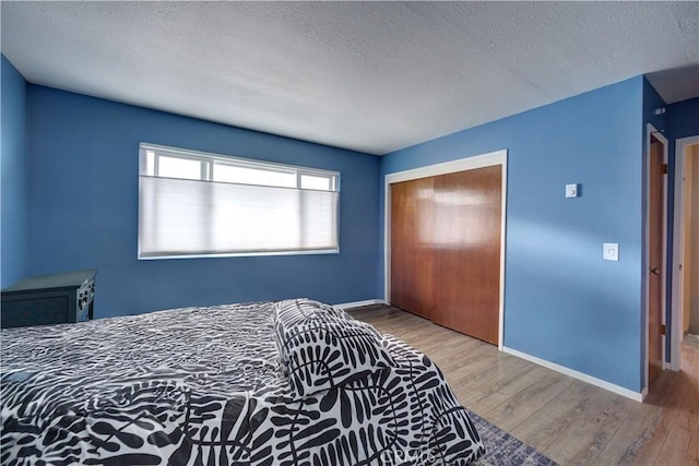 641 Piney Way Unit D, Morro Bay, CA 93442 - bedroom featuring a textured ceiling, wood finished floors, and a closet