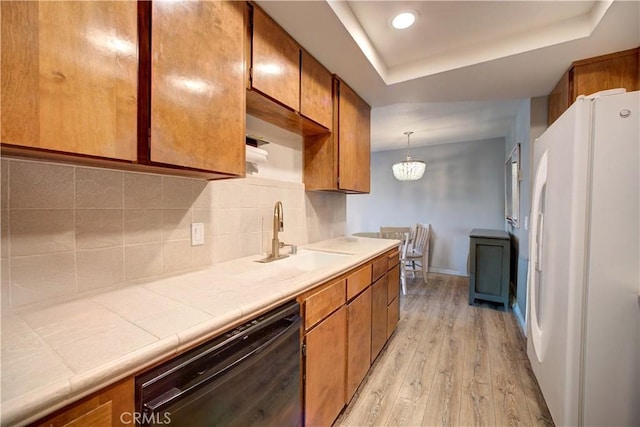 641 Piney Way Unit D, Morro Bay, CA 93442 - kitchen with freestanding refrigerator, dishwasher, brown cabinetry, and light wood-style flooring