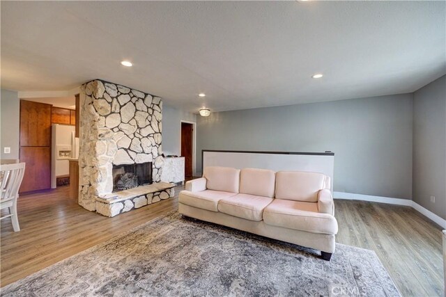 641 Piney Way Unit D, Morro Bay, CA 93442 - living room with wood finished floors, a fireplace, and recessed lighting
