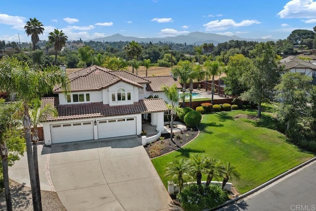 2270 Ritter Pl, Escondido, CA 92029 - view of front of property featuring a tile roof, a garage, driveway, stucco siding, and a mountain view