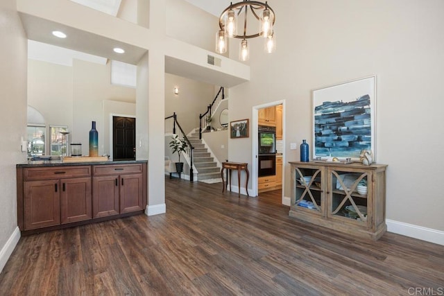 2270 Ritter Pl, Escondido, CA 92029 - bar with a high ceiling, dark wood-style flooring, stairs, a chandelier, and hanging light fixtures