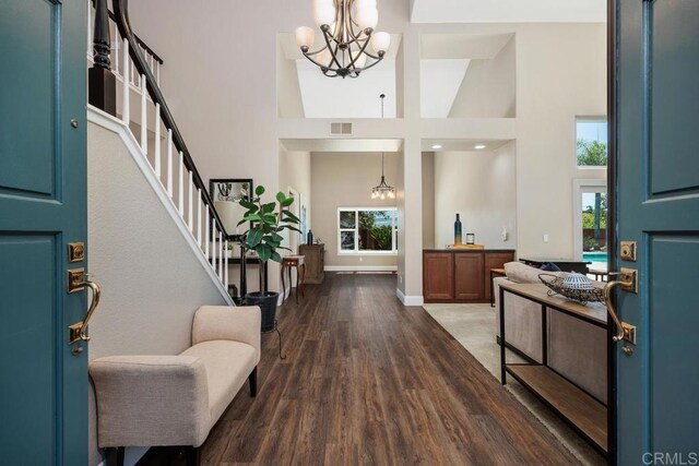2270 Ritter Pl, Escondido, CA 92029 - entrance foyer with a chandelier, healthy amount of natural light, a high ceiling, wood finished floors, and stairs
