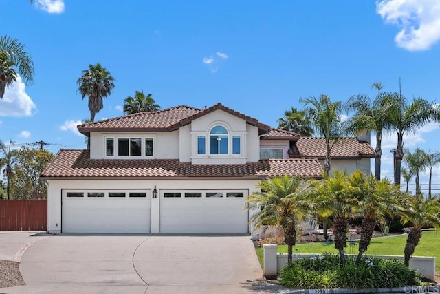 2270 Ritter Pl, Escondido, CA 92029 - mediterranean / spanish house with a tiled roof, stucco siding, driveway, and an attached garage