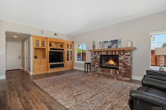 2270 Ritter Pl, Escondido, CA 92029 - living room featuring dark wood-type flooring, a fireplace, and healthy amount of natural light
