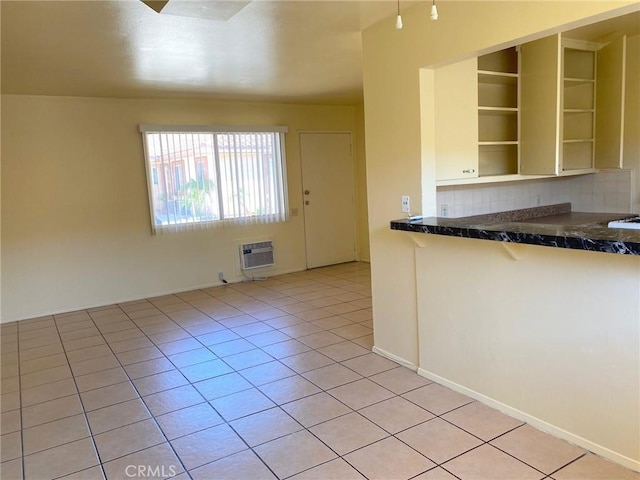438 W Ramona Dr, Rialto, CA 92376 - kitchen featuring open shelves, dark countertops, light tile patterned flooring, and decorative backsplash