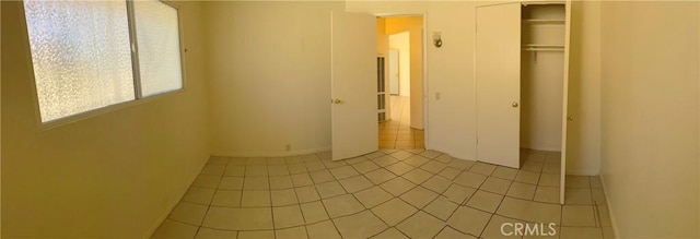 438 W Ramona Dr, Rialto, CA 92376 - unfurnished bedroom with a closet and light tile patterned floors