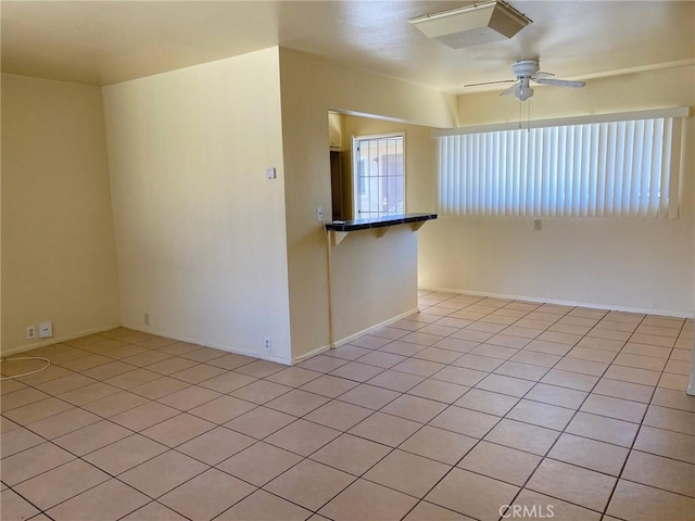 438 W Ramona Dr, Rialto, CA 92376 - empty room with ceiling fan and light tile patterned floors
