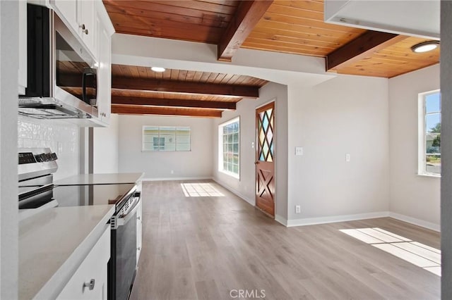 1625 Rose Ave, Merced, CA 95341 - kitchen featuring appliances with stainless steel finishes, a wood ceiling with exposed beams, light wood finished floors, white cabinets, and light countertops