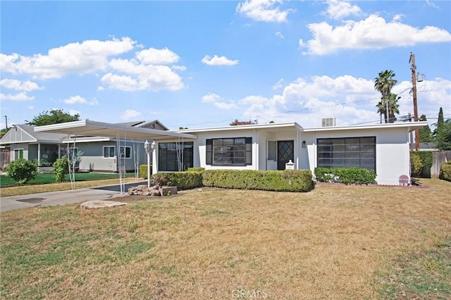 1625 Rose Ave, Merced, CA 95341 - view of front of house featuring a front yard, a carport, stucco siding, and concrete driveway
