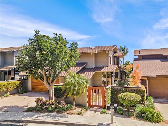 4 Woodhaven, Laguna Niguel, CA 92677 - view of front of home with concrete driveway, a garage, and a gate