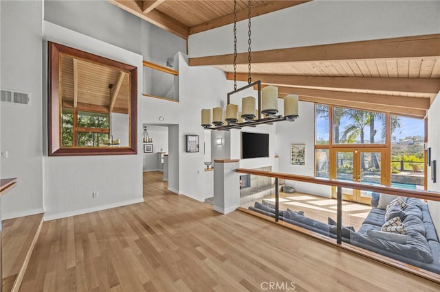 4 Woodhaven, Laguna Niguel, CA 92677 - unfurnished living room featuring a wood ceiling with exposed beams, healthy amount of natural light, wood finished floors, high vaulted ceiling, and a chandelier
