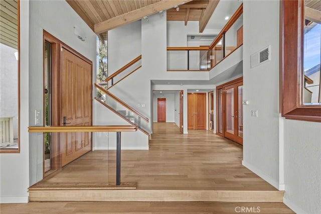 4 Woodhaven, Laguna Niguel, CA 92677 - entrance foyer featuring stairs, a wood ceiling with exposed beams, wood finished floors, french doors, and a high ceiling