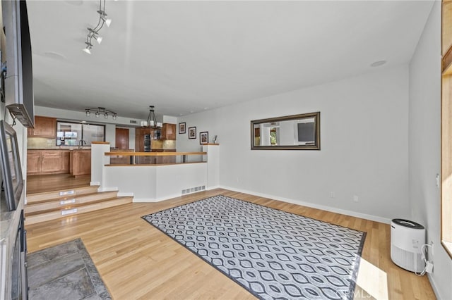 4 Woodhaven, Laguna Niguel, CA 92677 - unfurnished living room with light wood-style floors and rail lighting