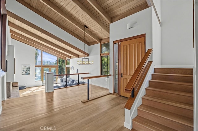 4 Woodhaven, Laguna Niguel, CA 92677 - foyer featuring a wooden ceiling with exposed beams, high vaulted ceiling, stairway, light wood-style floors, and a chandelier