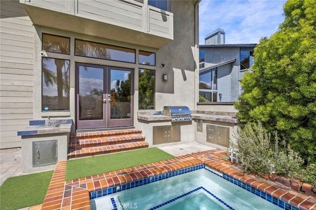 4 Woodhaven, Laguna Niguel, CA 92677 - entrance to property with an outdoor kitchen, french doors, stucco siding, and a patio