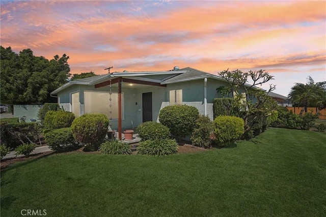 5801 Repetto Ave, East Los Angeles, CA 90022 - view of front of property featuring a lawn and stucco siding