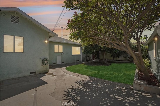 5801 Repetto Ave, East Los Angeles, CA 90022 - back of property at dusk featuring a patio area, stucco siding, and crawl space