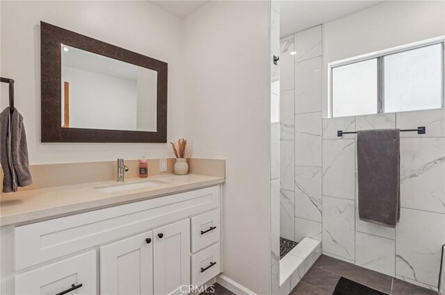 5801 Repetto Ave, East Los Angeles, CA 90022 - full bath featuring vanity, a marble finish shower, and marble look tile flooring