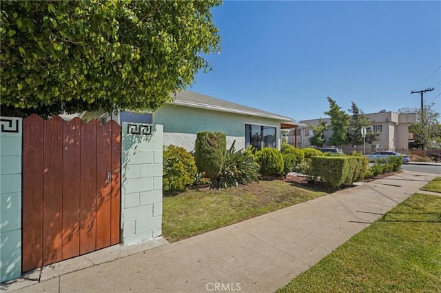 5801 Repetto Ave, East Los Angeles, CA 90022 - view of front of house featuring stucco siding and a front lawn