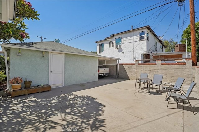 5801 Repetto Ave, East Los Angeles, CA 90022 - back of property with stucco siding and a patio
