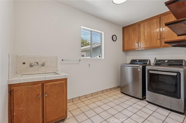5801 Repetto Ave, East Los Angeles, CA 90022 - washroom with washing machine and clothes dryer, cabinet space, and light tile patterned flooring