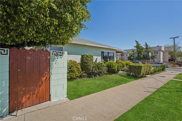 5801 Repetto Ave, East Los Angeles, CA 90022 - view of front of home with a front yard and stucco siding