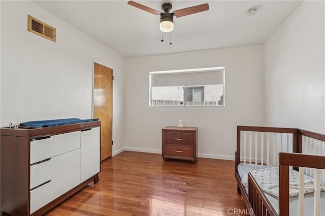 5801 Repetto Ave, East Los Angeles, CA 90022 - bedroom with wood finished floors and a crib