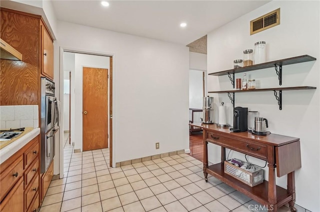 5801 Repetto Ave, East Los Angeles, CA 90022 - kitchen with open shelves, brown cabinetry, recessed lighting, and double oven