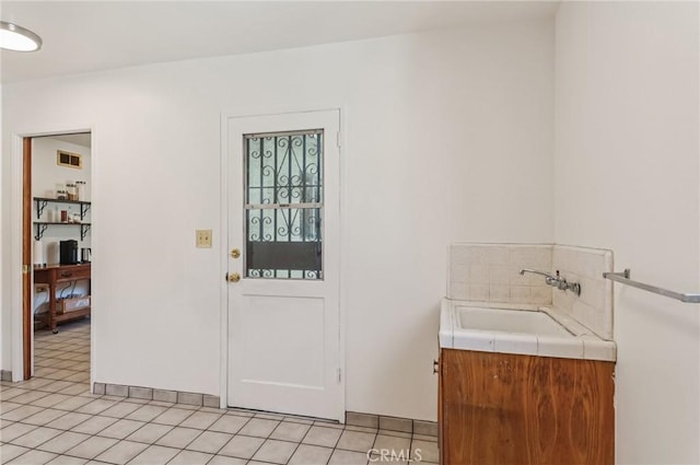 5801 Repetto Ave, East Los Angeles, CA 90022 - foyer entrance with light tile patterned floors and baseboards