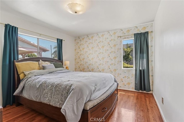 5801 Repetto Ave, East Los Angeles, CA 90022 - bedroom with wood finished floors and wallpapered walls