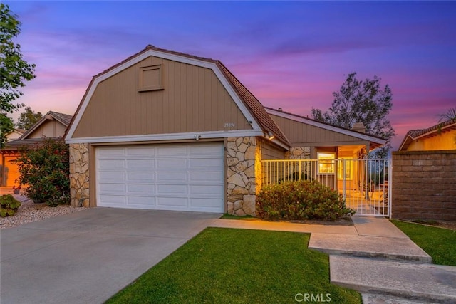 21094 Trailside Dr, Yorba Linda, CA 92887 - view of front of property with stone siding, a gambrel roof, a garage, and concrete driveway