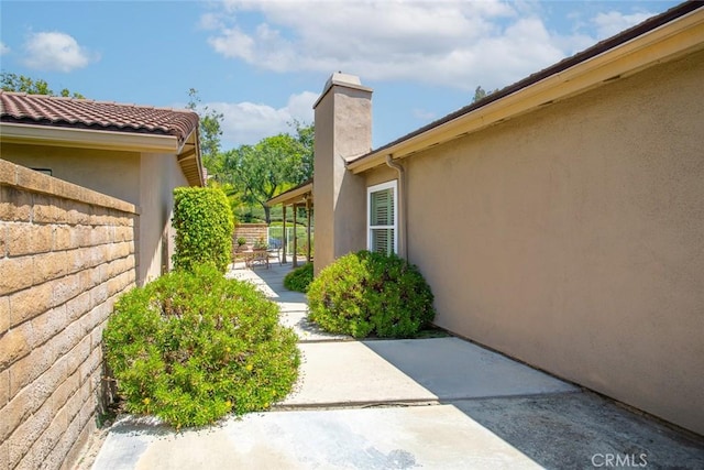 21094 Trailside Dr, Yorba Linda, CA 92887 - property entrance with a patio area, stucco siding, and a chimney