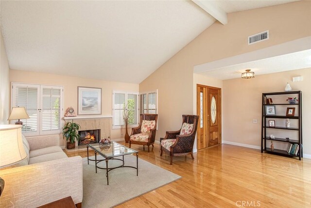 21094 Trailside Dr, Yorba Linda, CA 92887 - living room featuring light wood-type flooring, beam ceiling, a premium fireplace, and high vaulted ceiling